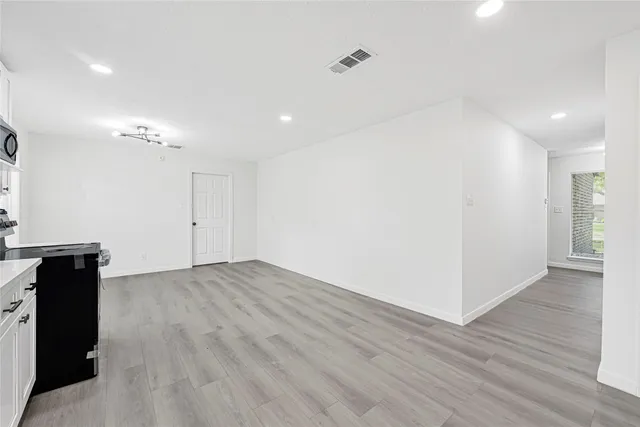 a view of a room with wooden floor