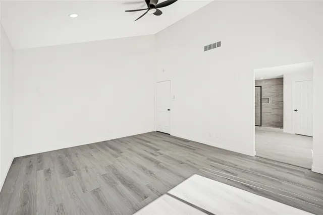 a view of a room with wooden floor