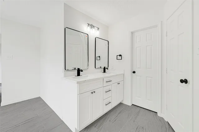 a spacious bathroom with a double vanity sink mirror and double