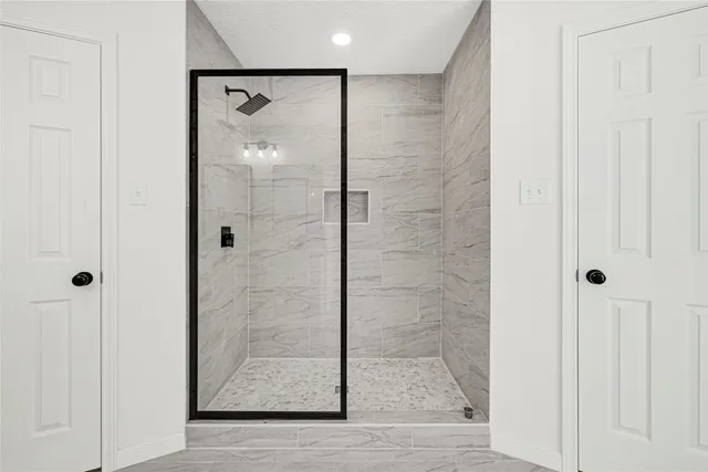a bathroom with a glass shower door