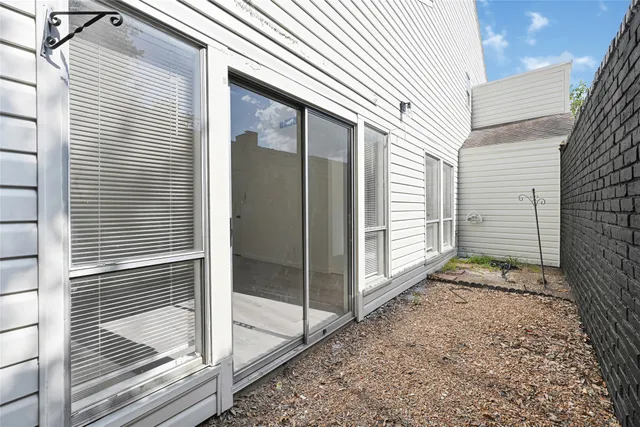 a view of a porch with a door and wooden floor