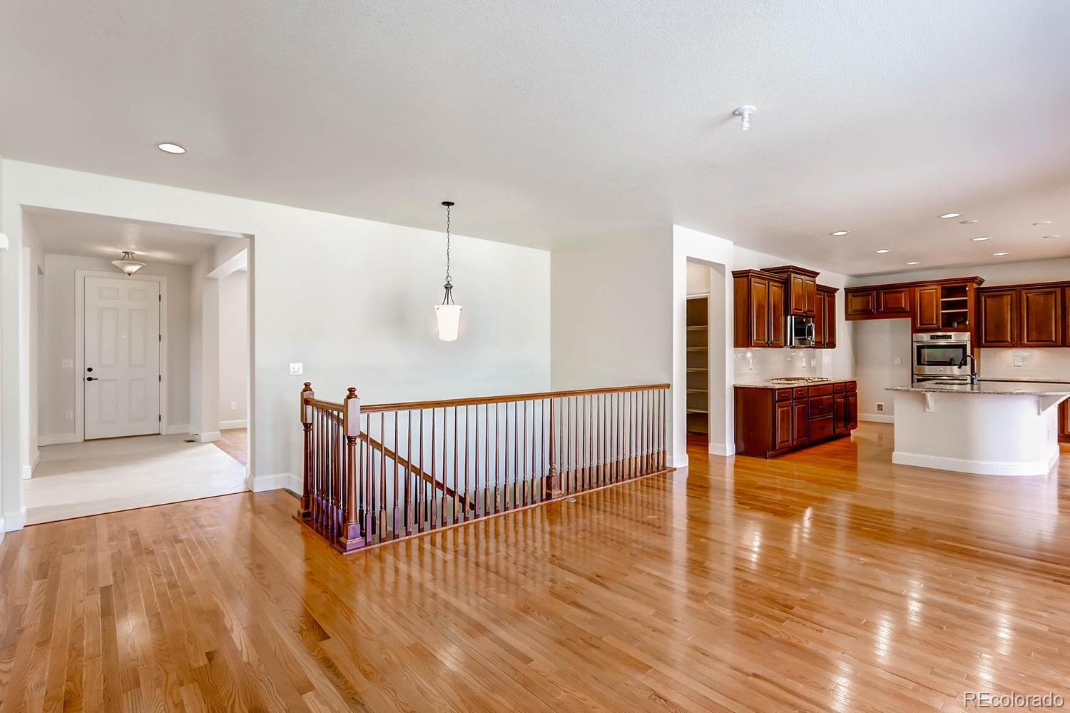 10845 Graphite Street Broomfield, CO 80021 - Photo 8 of 25 a view of a living room and kitchen with a large window