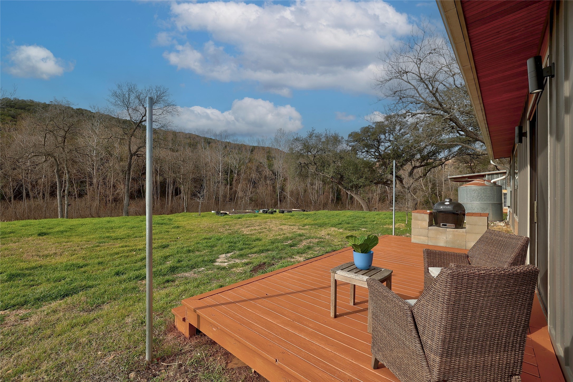7001 Ranch Road 2222 Austin, TX 78730 - Photo 18 of 18 A spacious wooden deck extends to a verdant landscape, ideal for outdoor gatherings.
