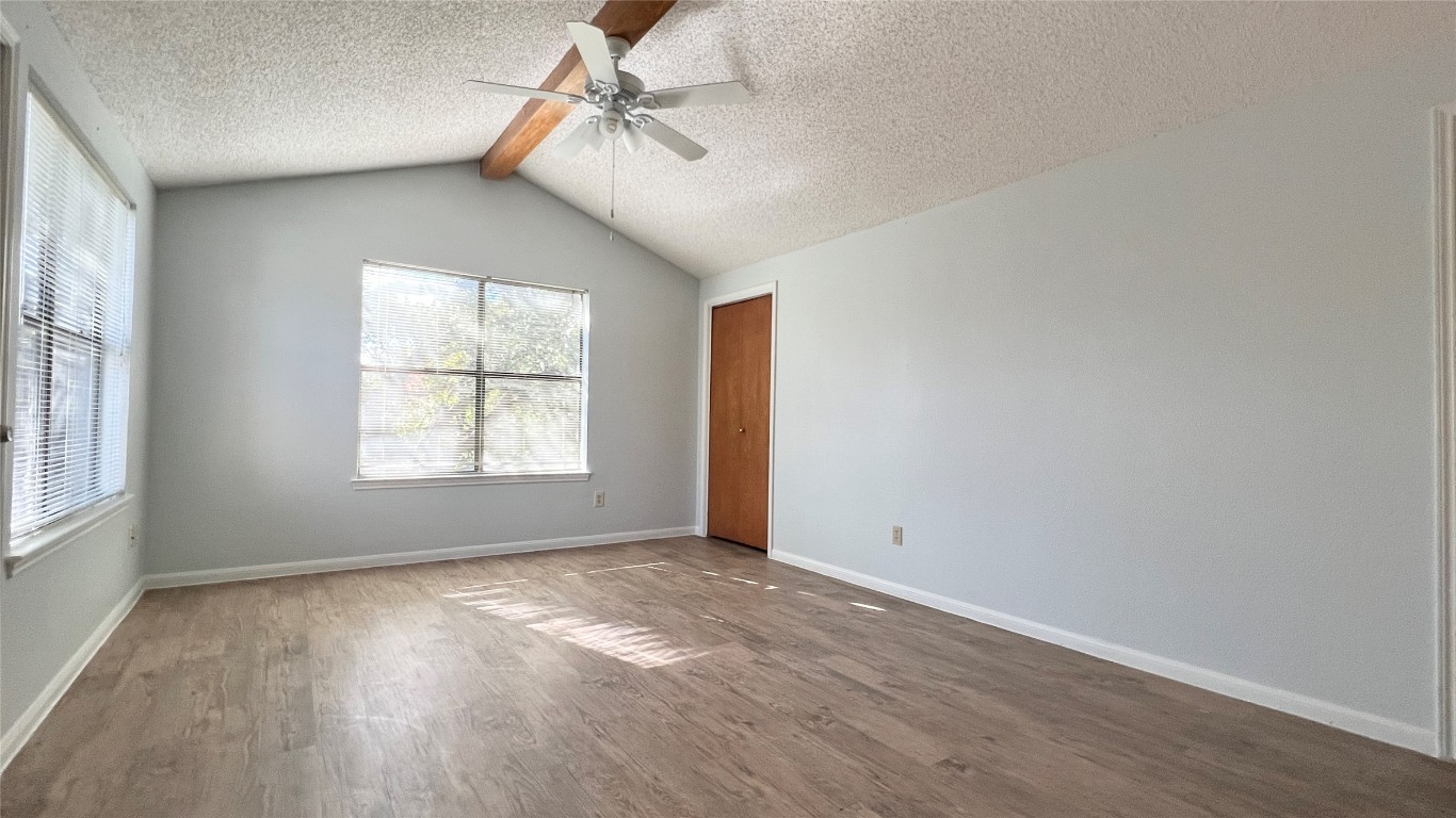 9201 Simmons Road, Unit 101 Austin, TX 78759 - Photo 5 of 10 an empty room with wooden floor and windows