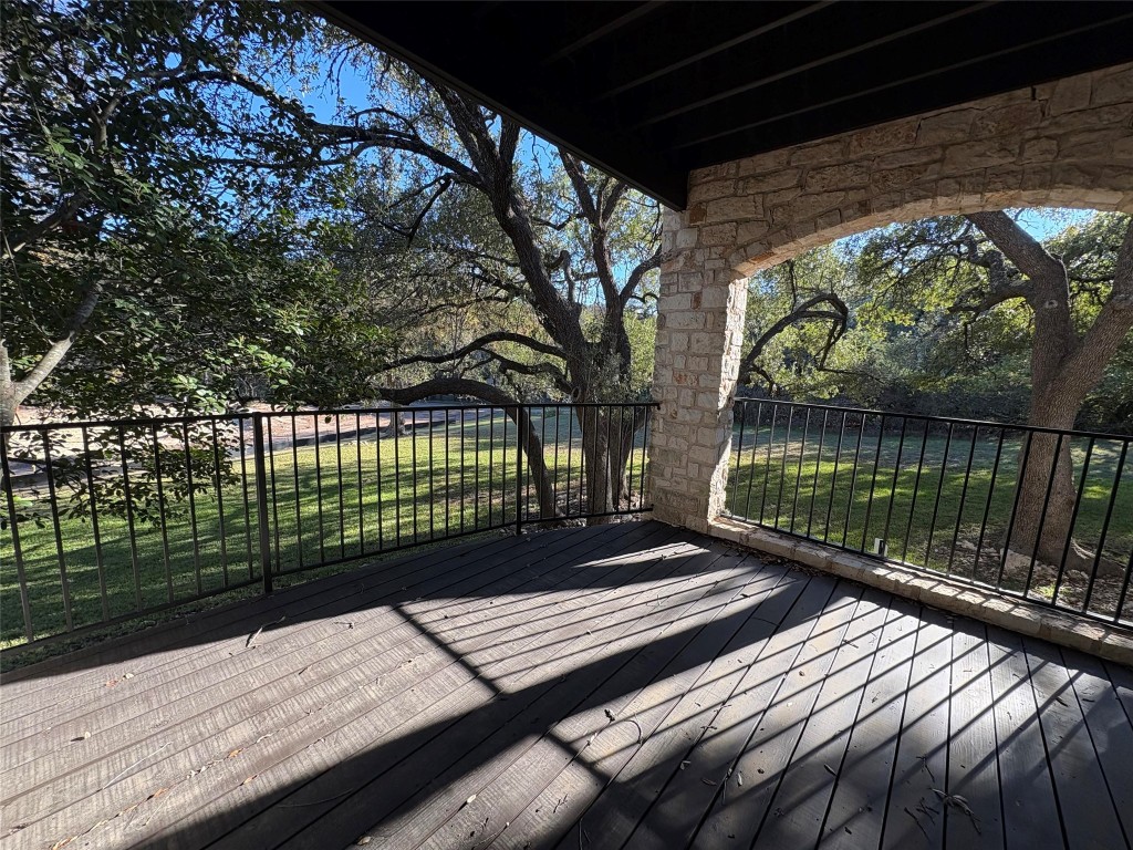 9201 Simmons Road, Unit 101 Austin, TX 78759 - Photo 8 of 10 a view of a roof deck with wooden floor and fence
