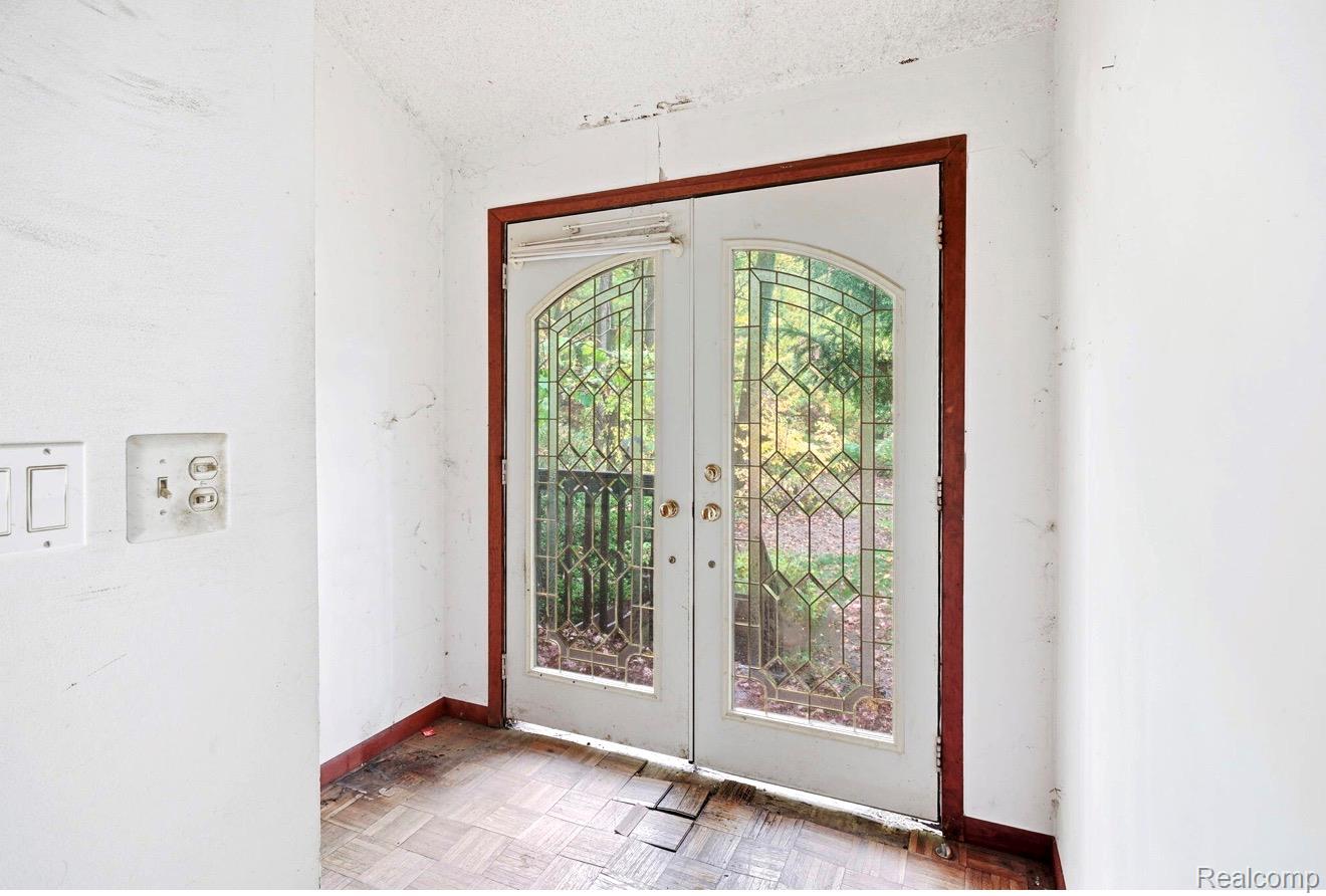 8890 Tipsico Lake Road Holly, MI 48442 - Photo 16 of 20 Dual French doors with leaded glass panels and arched tops