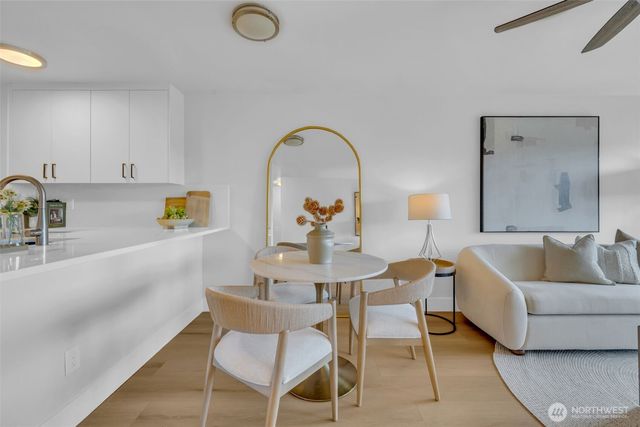 a living room with furniture and a dining table
