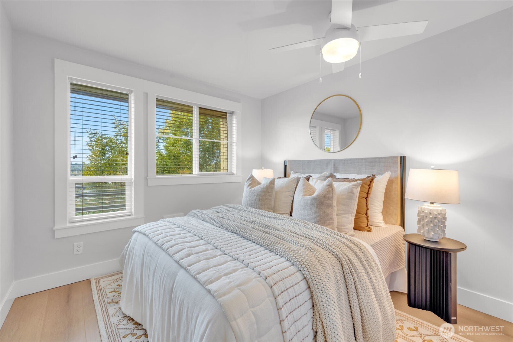 3401 Wallingford Avenue North, Unit 405 Seattle, WA 98103 - Photo 17 of 28 a bedroom with bed and wooden floor
