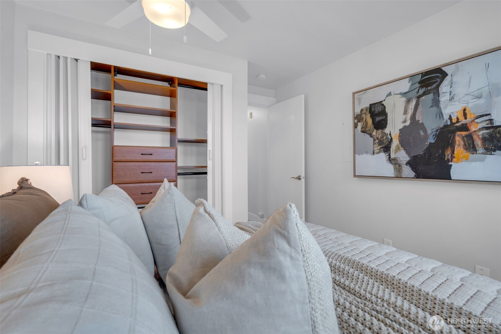 3401 Wallingford Avenue North, Unit 405 Seattle, WA 98103 - Photo 19 of 28 a bedroom with a bed and a painting on the wall