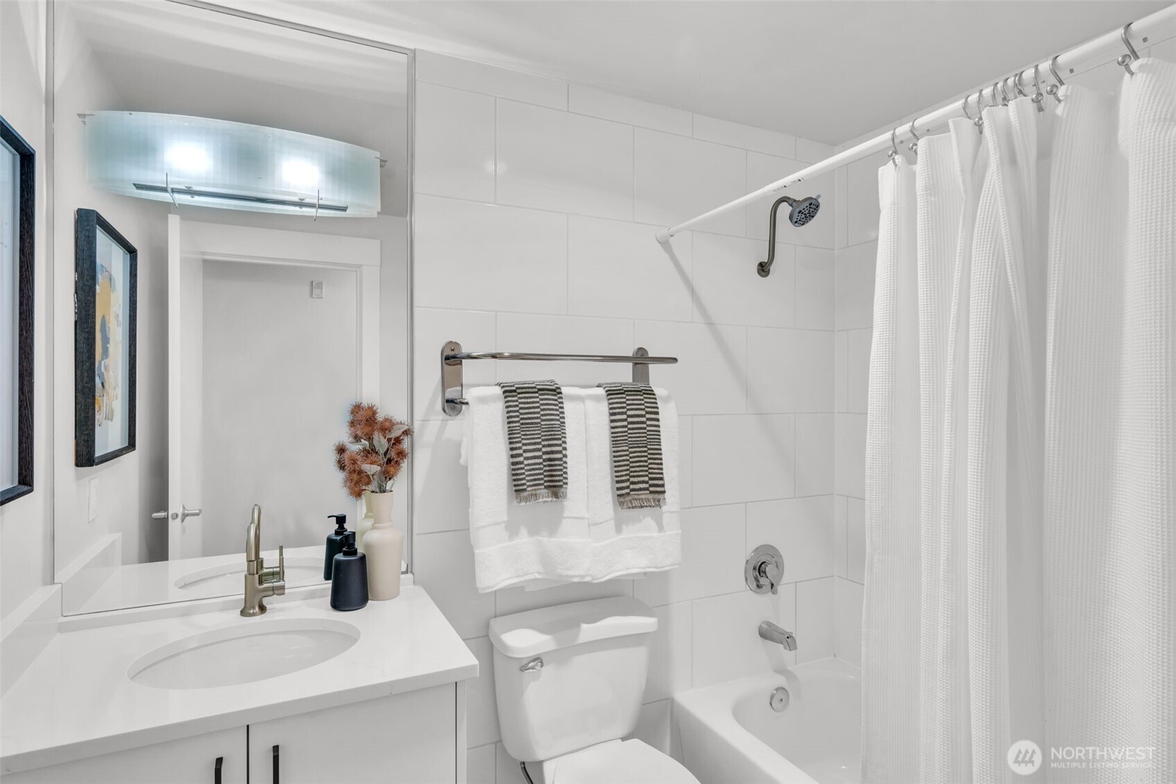 3401 Wallingford Avenue North, Unit 405 Seattle, WA 98103 - Photo 20 of 28 a bathroom with a sink a toilet and shower