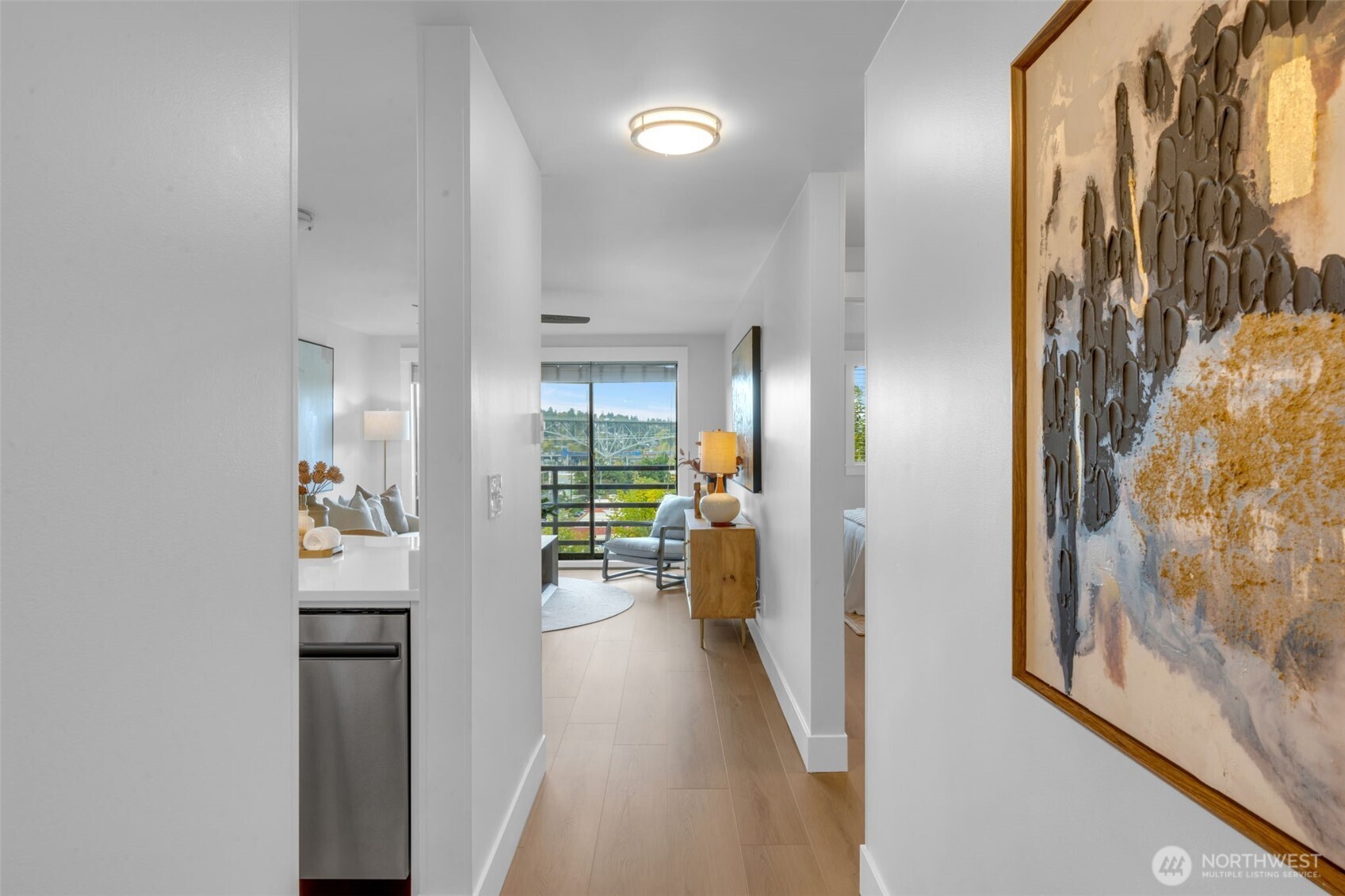 3401 Wallingford Avenue North, Unit 405 Seattle, WA 98103 - Photo 3 of 28 a view of a hallway and a livingroom with furniture