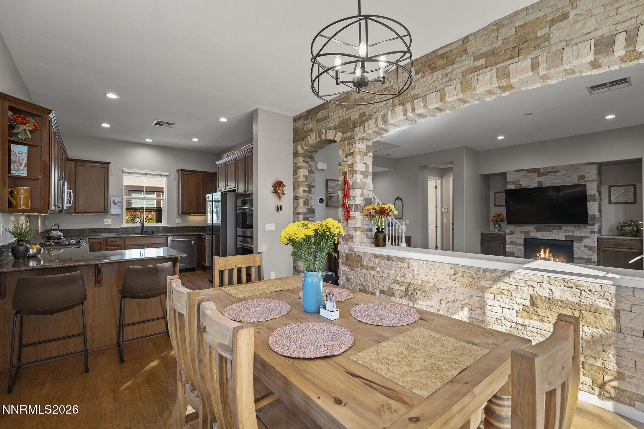 2220 Heavenly View Trail Reno, NV 89523 - Photo 7 of 29 a kitchen with stainless steel appliances kitchen island granite countertop a table and chairs in it