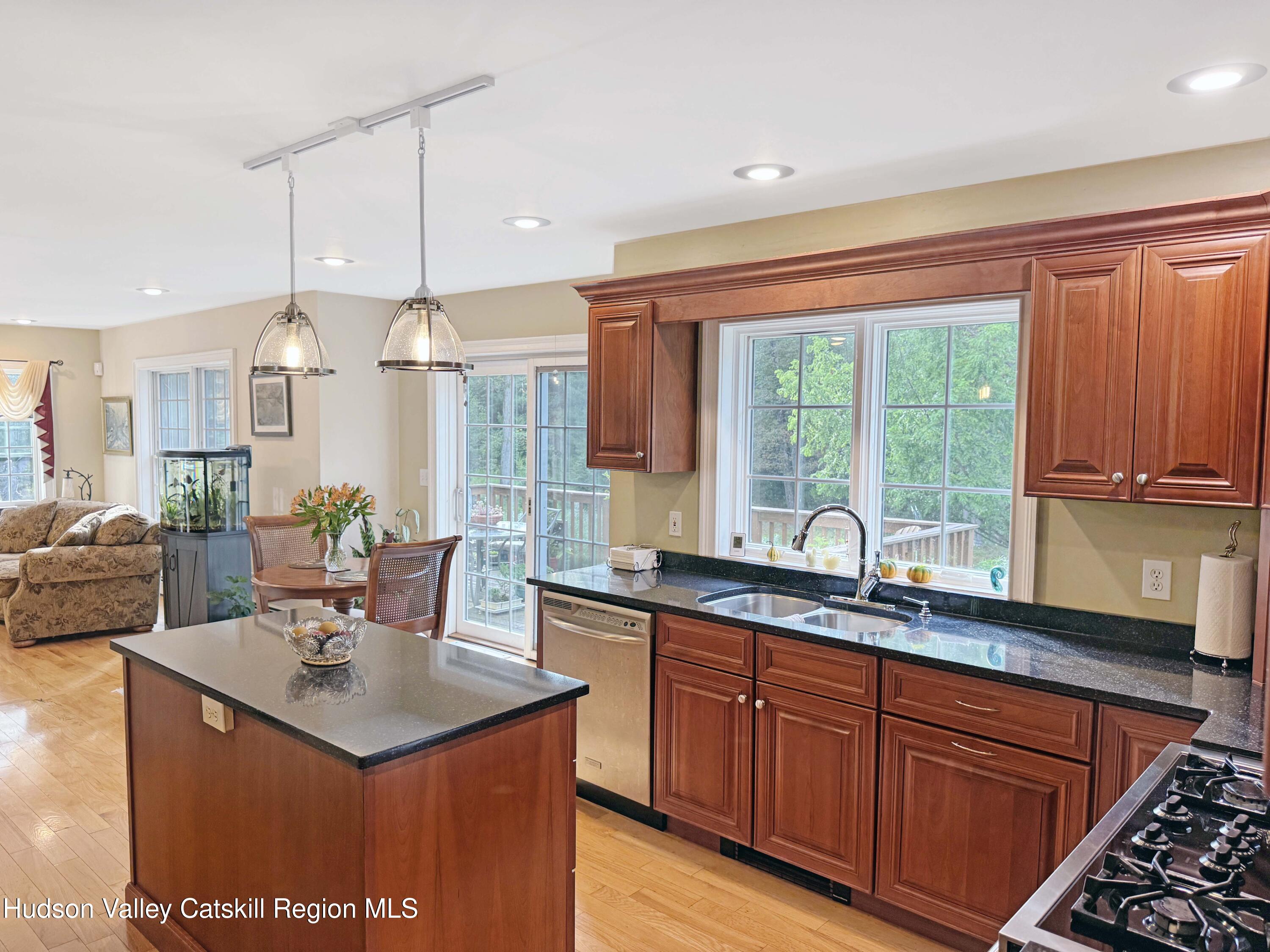 189 Bush Road Stone Ridge, NY 12484 - Photo 12 of 35 a kitchen with stainless steel appliances granite countertop a sink a stove and a refrigerator