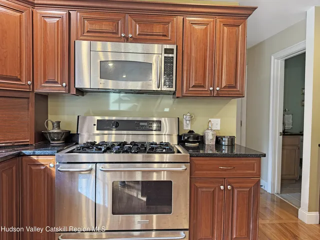 a kitchen with stainless steel appliances granite countertop a stove and a microwave
