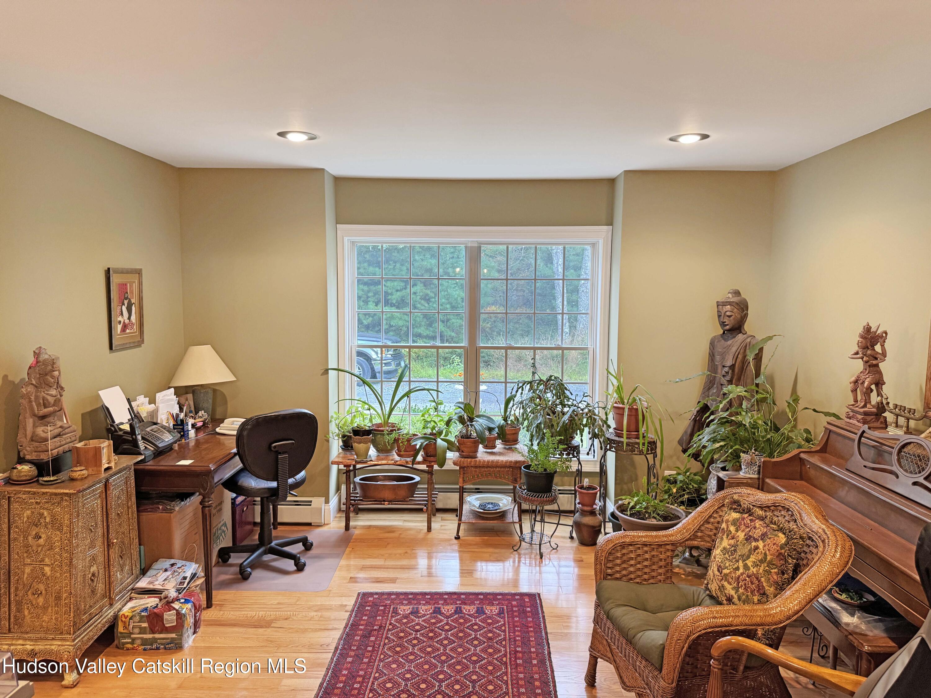 189 Bush Road Stone Ridge, NY 12484 - Photo 16 of 35 a living room with furniture a rug and a potted plant