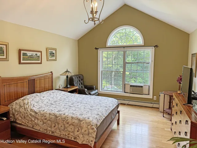 a bed sitting in a bedroom next to a window