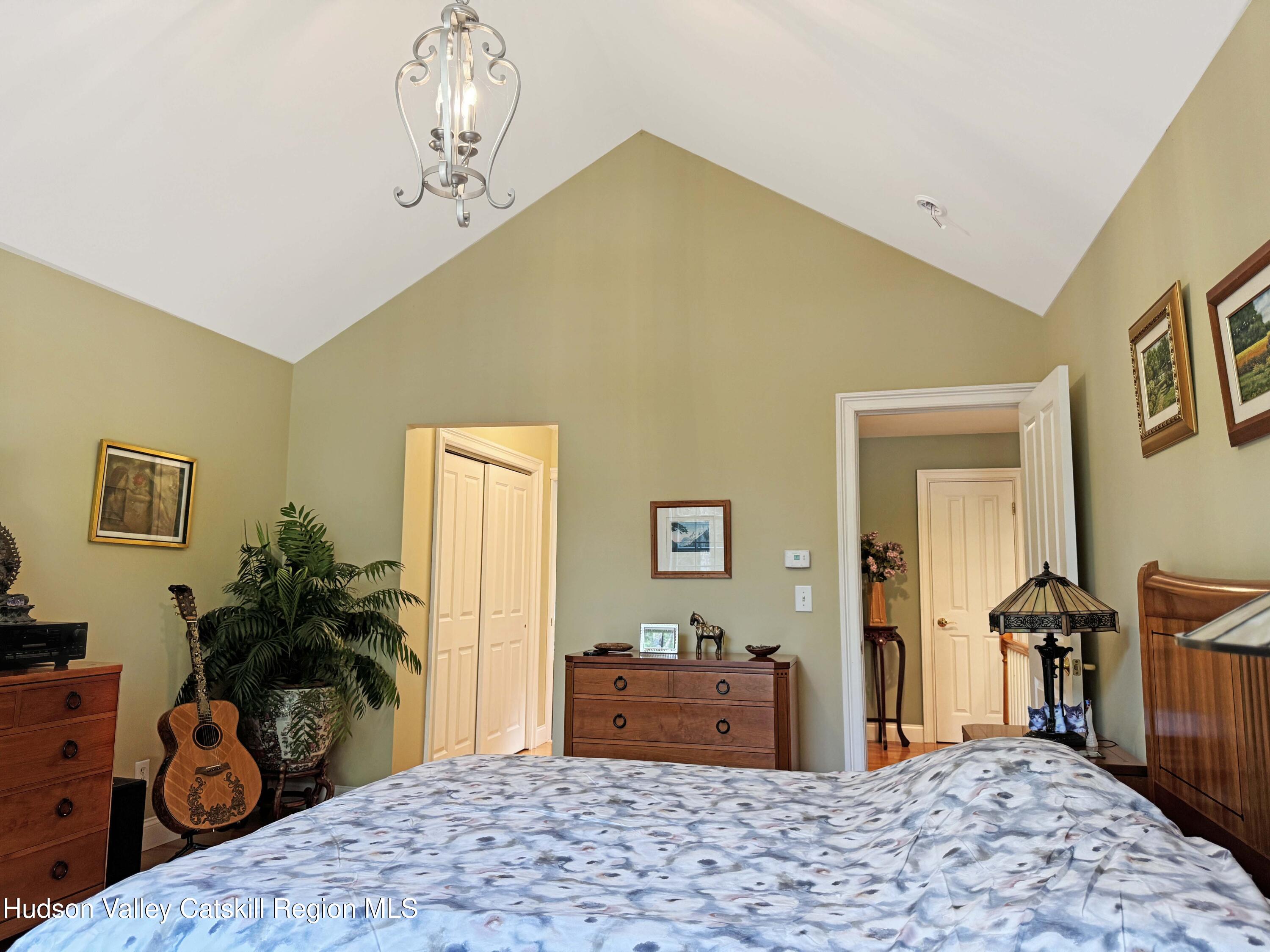 189 Bush Road Stone Ridge, NY 12484 - Photo 19 of 35 a bedroom with a bed and a dresser in it