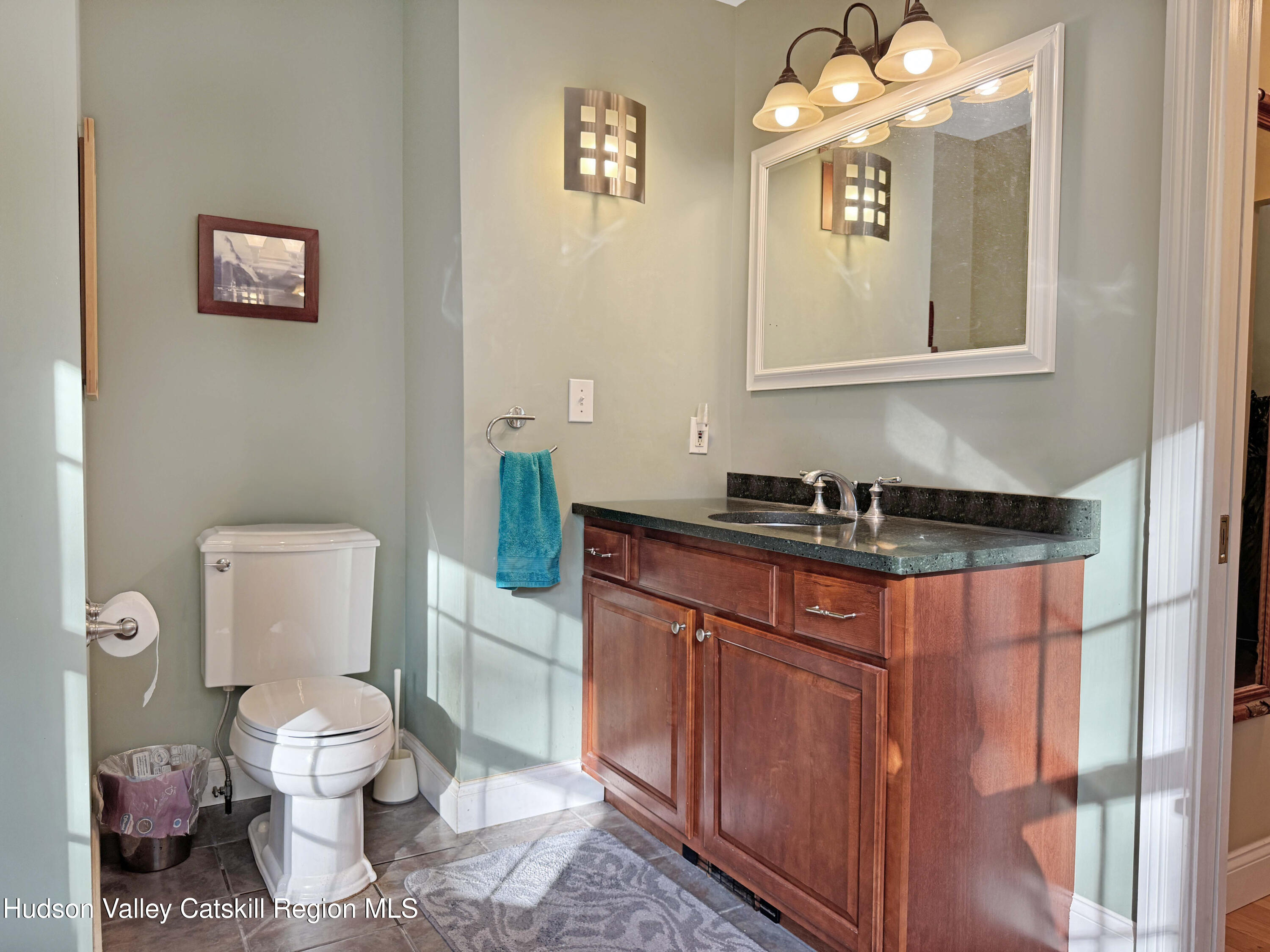 189 Bush Road Stone Ridge, NY 12484 - Photo 22 of 35 a bathroom with a toilet sink and mirror
