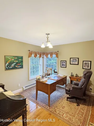 a living room with furniture and book shelf