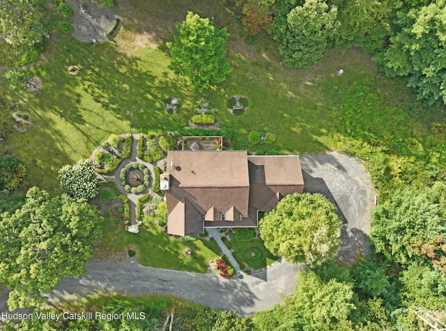 an aerial view of a house with a yard and garden