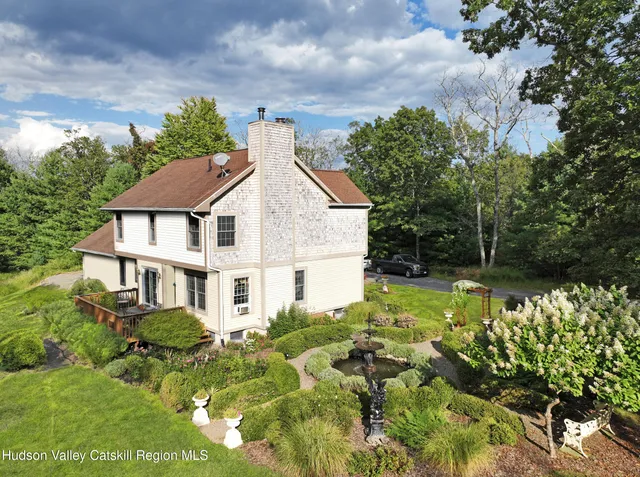 a view of a house with a yard and garden