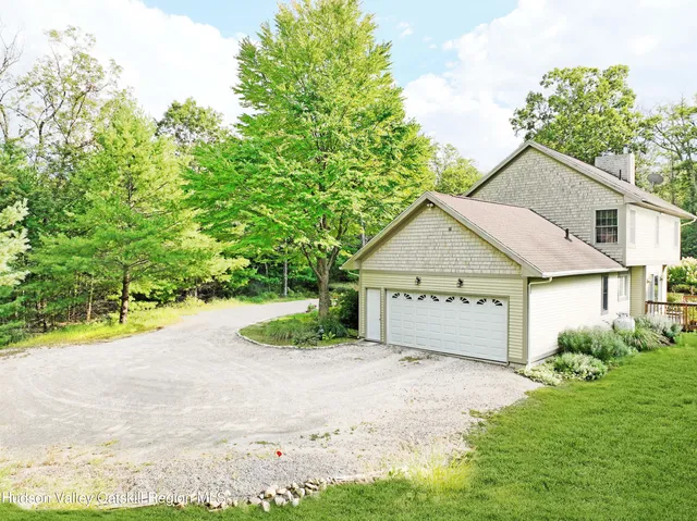 a view of front of house with a yard and garage