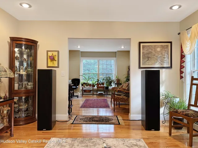 a living room with furniture a lamp and large window