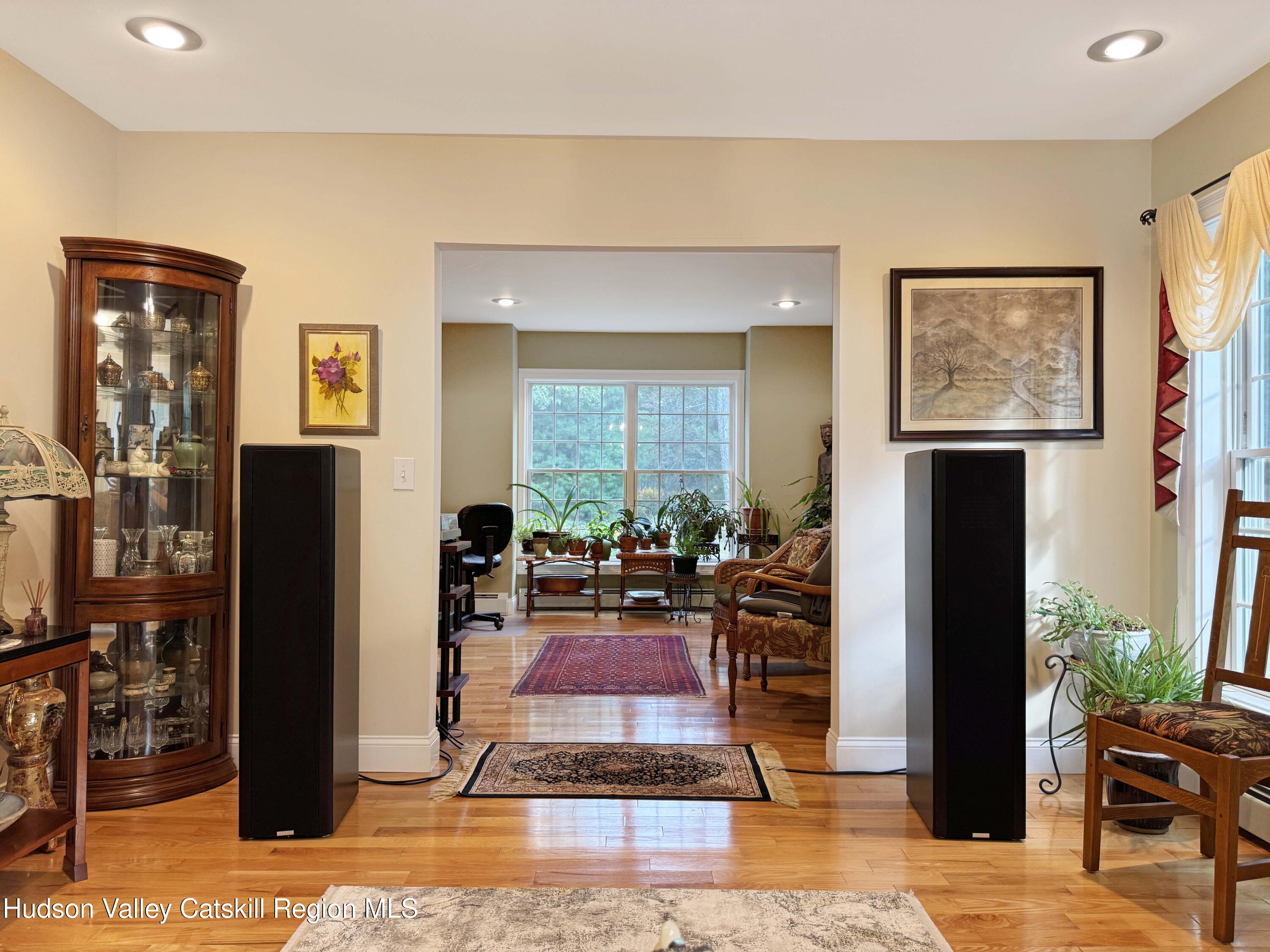 189 Bush Road Stone Ridge, NY 12484 - Photo 9 of 35 a living room with furniture a lamp and large window