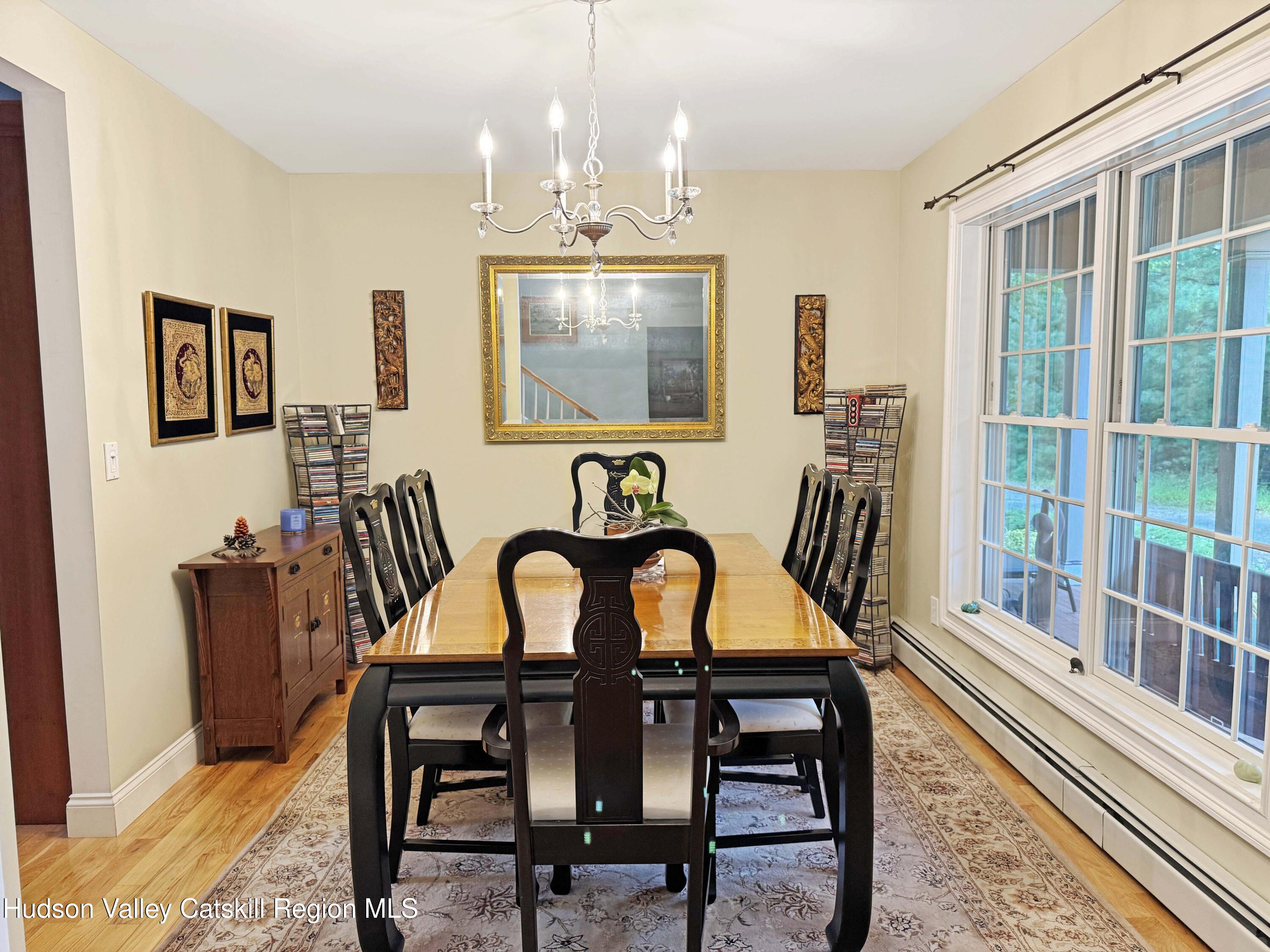 189 Bush Road Stone Ridge, NY 12484 - Photo 10 of 35 a dining room with furniture a rug and wooden floor