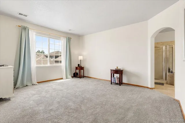 a view of walk in closet with clothes