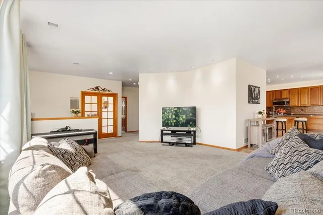 a view of a bedroom with furniture and a flat screen tv