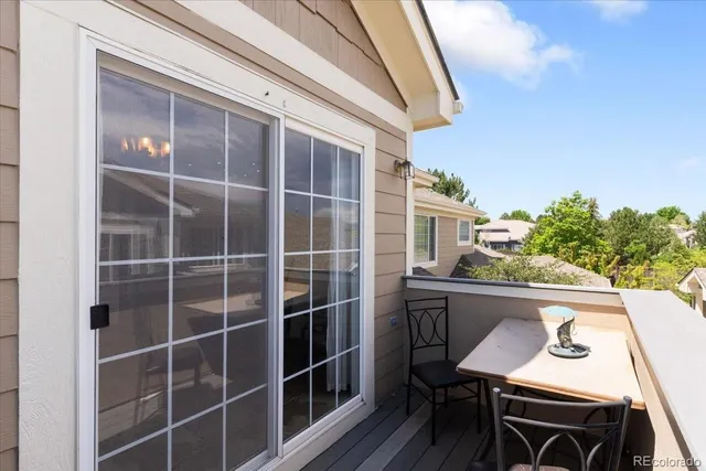 a balcony with table and chairs