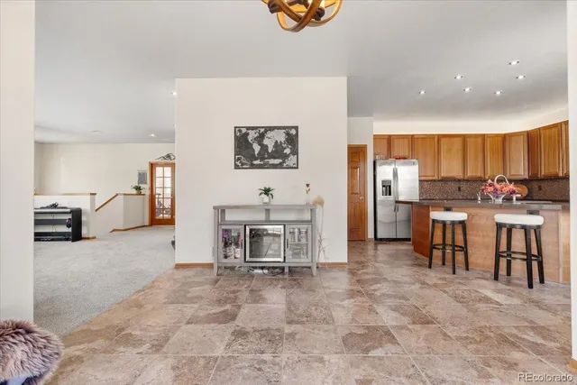 a view of kitchen with furniture and refrigerator