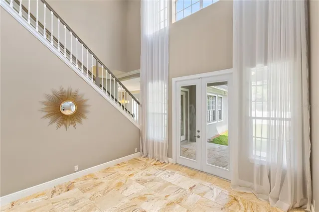 a view of a big room with wooden floor and windows