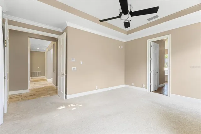 an empty room with closet and windows