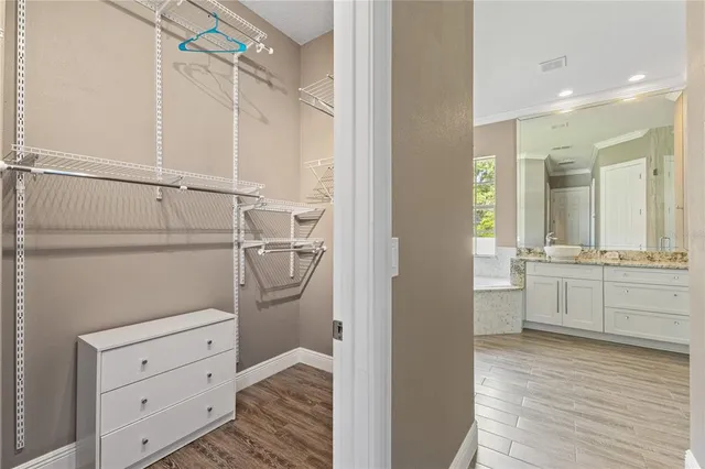 a bathroom with a granite countertop sink two mirror and a shower