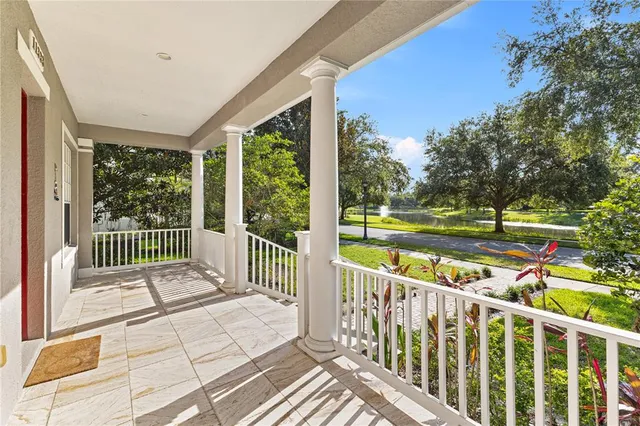 a view of a porch with wooden floor next to a yard