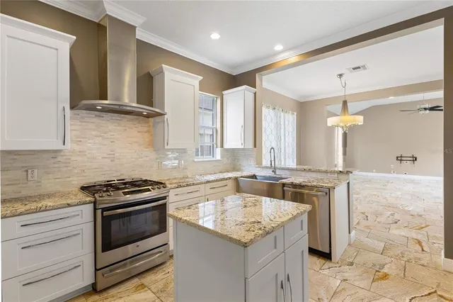 a kitchen with granite countertop a sink stove and cabinets