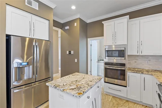 a living room with furniture flat screen tv and a large window