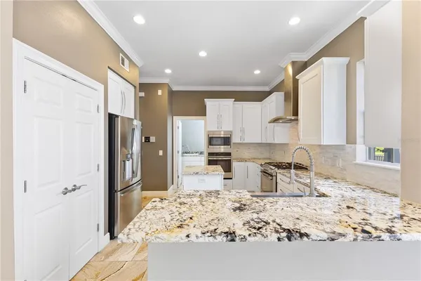 a living room with furniture flat screen tv and a large window