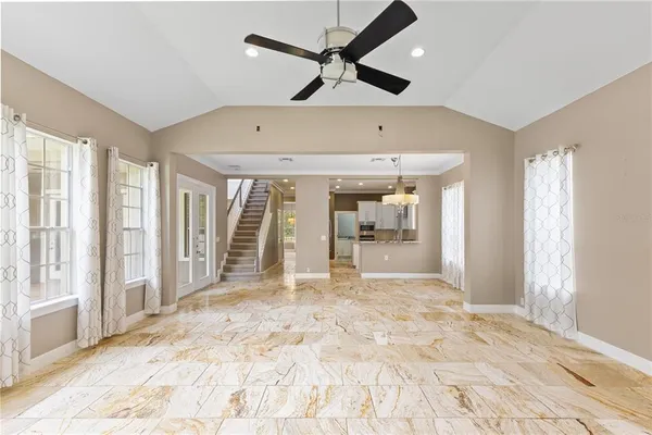 a view of an empty room with closet and a window