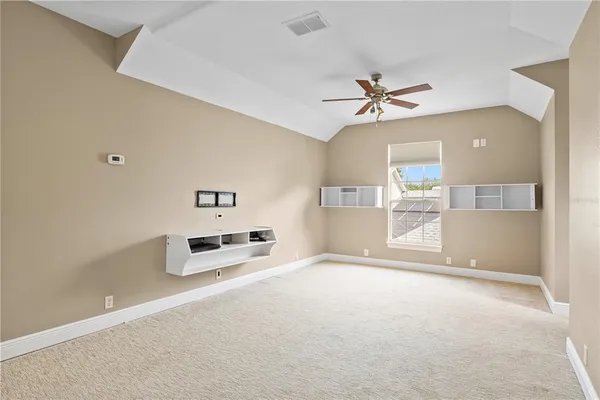a view of a livingroom with a ceiling fan and window