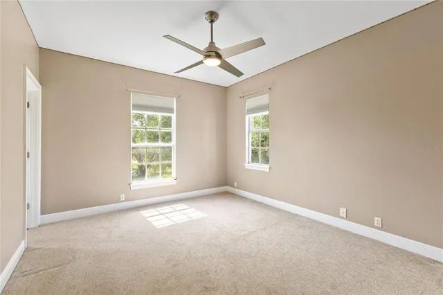 an empty room with windows and closet