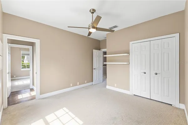 an empty room with windows and closet