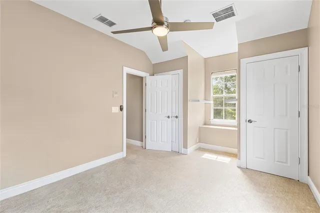 an aerial view of residential houses with outdoor space and trees