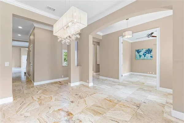 a view of a dining room with furniture large window and chandelier