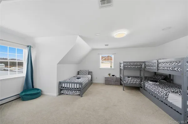 a bedroom with furniture and a lamp