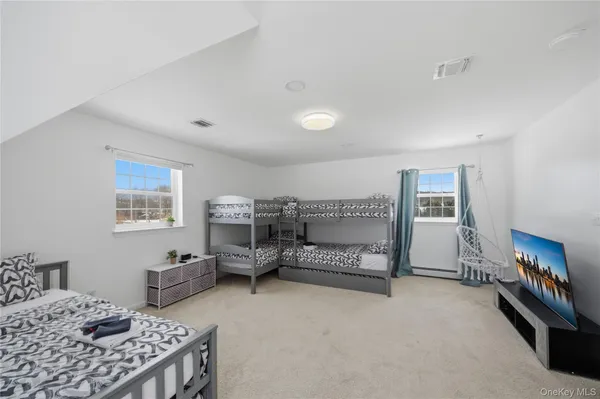a bedroom with furniture and a window