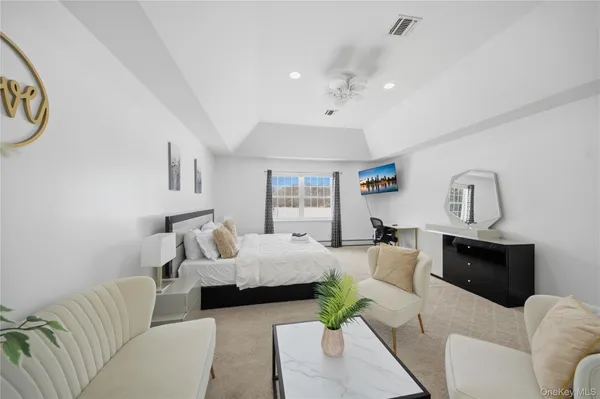 a bedroom with a bed and a couch