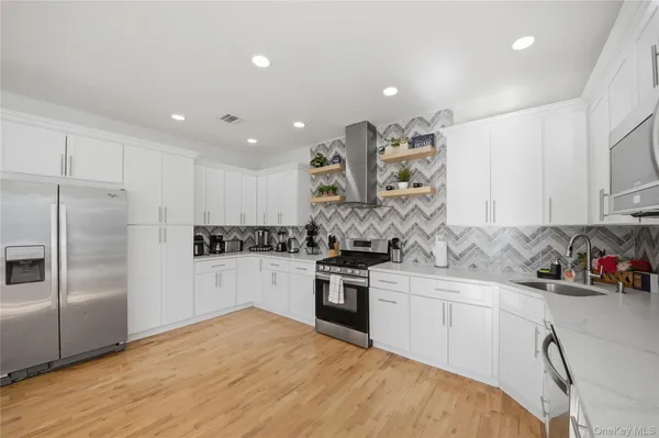 a kitchen with a sink stainless steel appliances and cabinets